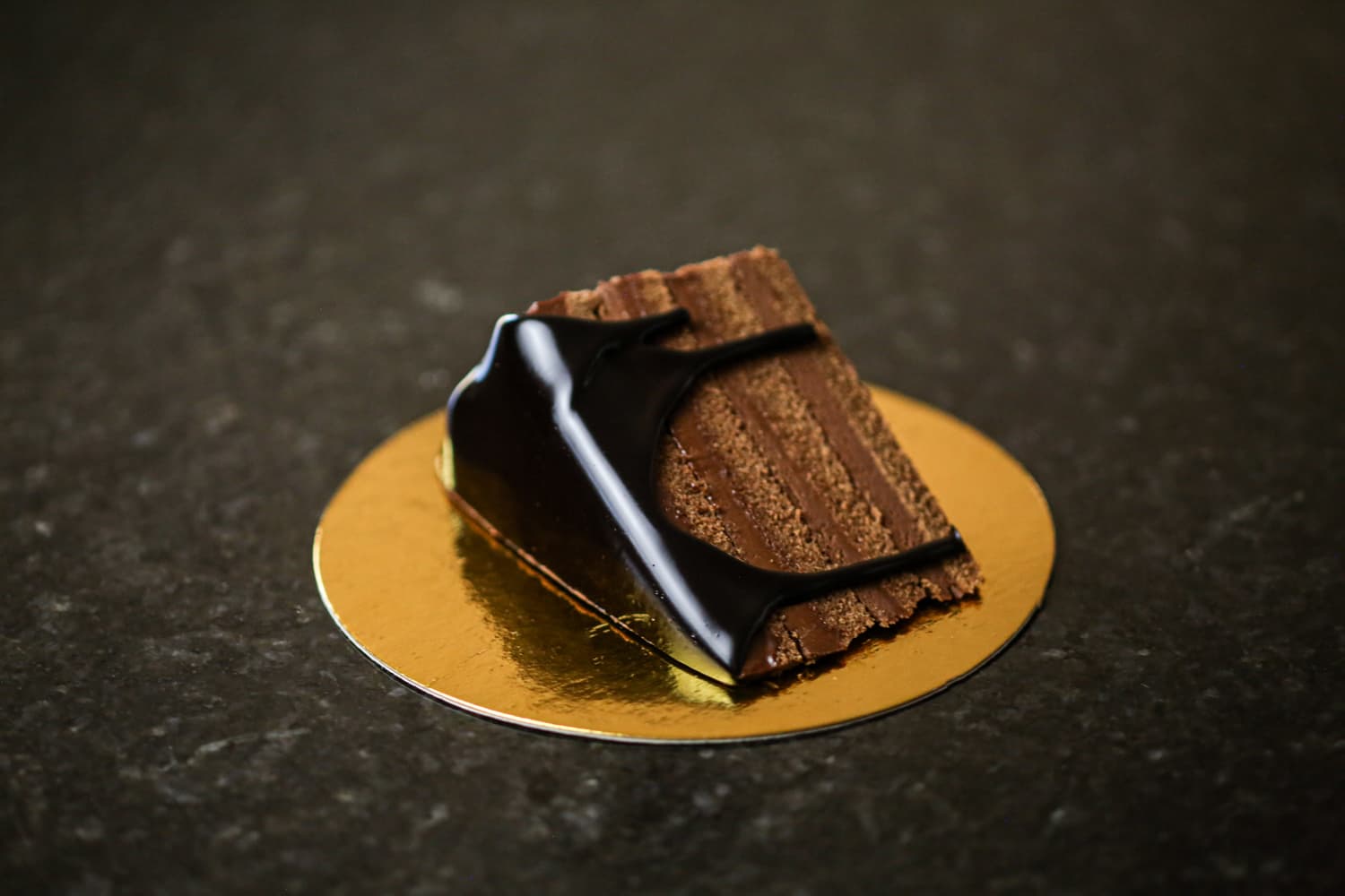 Chocolate mousse cake on golden platter.